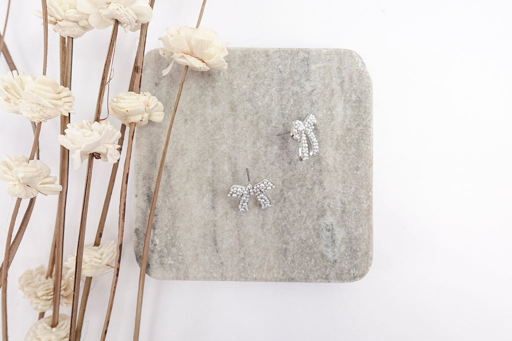 Silver Toned Pearl Bow Stud Earrings